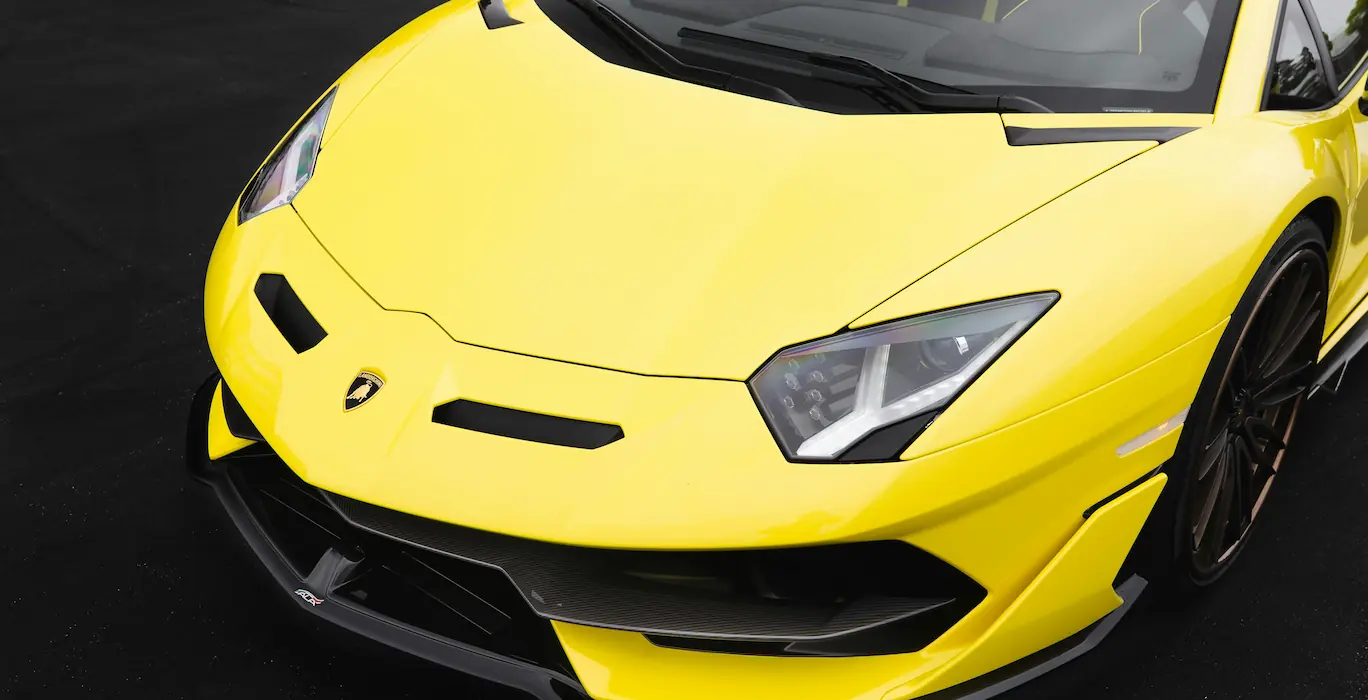 a yellow lamborghini parked on a clean road. remember to change this image description and delete the comment when changing the image out!